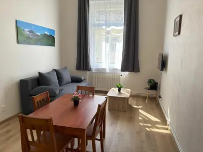 a living room with a table and a couch at Prague Deluxe City Center Apartment in Prague
