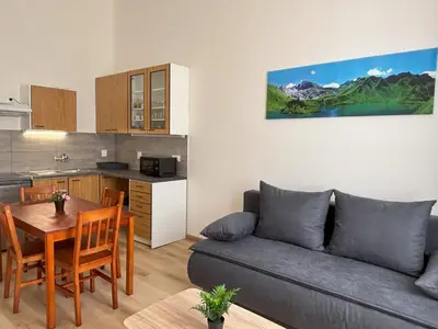 a living room with a couch and a table at Prague Deluxe City Center Apartment in Prague