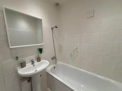 a bathroom with a sink and a tub and a mirror at Prague Deluxe City Center Apartment in Prague