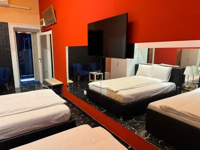 a room with three beds and a flat screen tv at VIP 1-Wenceslas square in Prague