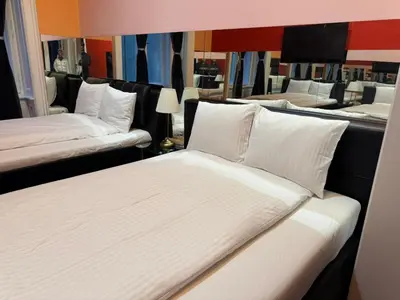 a room with three beds with white pillows at VIP 1-Wenceslas square in Prague