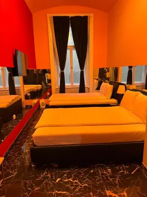 two beds in a room with orange walls at VIP 1-Wenceslas square in Prague
