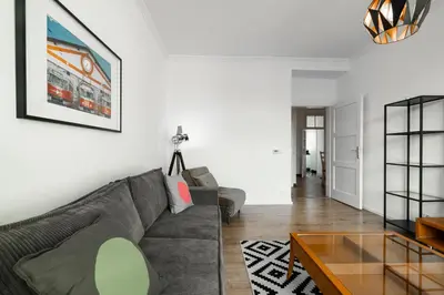 a living room with a couch and a table at Tram Depot Loft in Prague