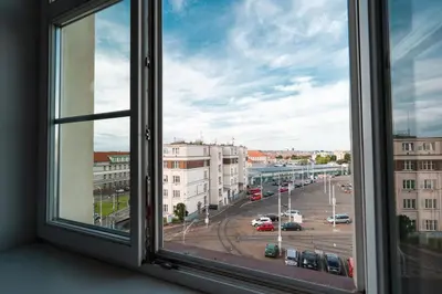 an open window with a view of a parking lot at Tram Depot Loft in Prague