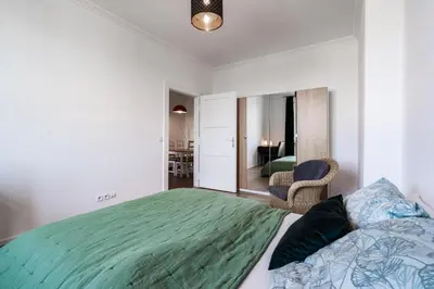 a bedroom with a large bed and a mirror at Tram Depot Loft in Prague