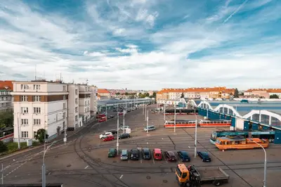 a city with cars parked in a parking lot at Tram Depot Loft in Prague