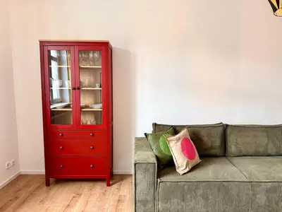 a red cabinet in a living room with a couch at Tram Depot Loft in Prague