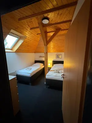a room with two beds and a window at Dvůr Stupice