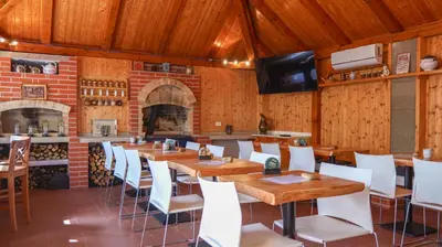 a dining room with wooden tables and white chairs at Dvůr Stupice