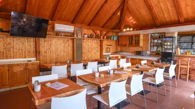 a dining room with wooden tables and white chairs at Dvůr Stupice
