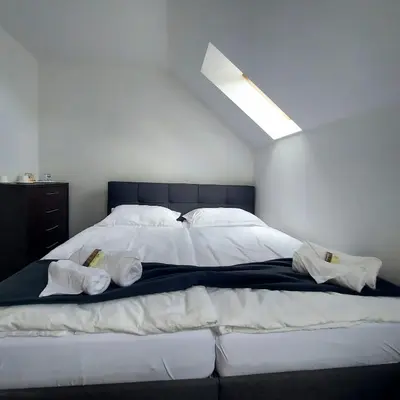 a bedroom with a large bed with towels on it at Dvůr Stupice