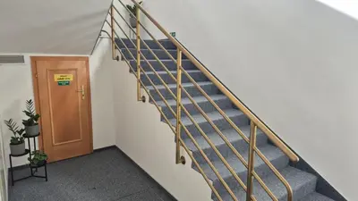 a stairwell in a building with a wooden door at Hotel Radnice Dobrovice in Dobrovice