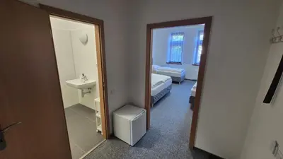 a room with a bathroom with a sink and a mirror at Hotel Radnice Dobrovice in Dobrovice