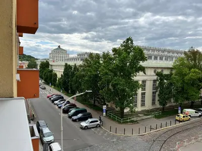 a city street with cars parked in front of a building at Home By The River in Prague