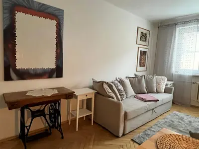a living room with a couch and a table at Home By The River in Prague