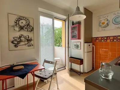 a kitchen with a small table and a refrigerator at Home By The River in Prague