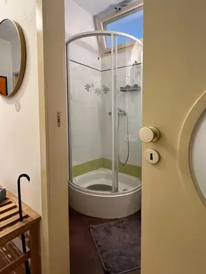 a bathroom with a shower and a bath tub at Home By The River in Prague