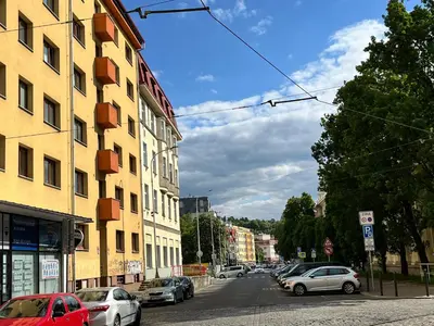 a street with cars parked on the side of a building at Home By The River in Prague