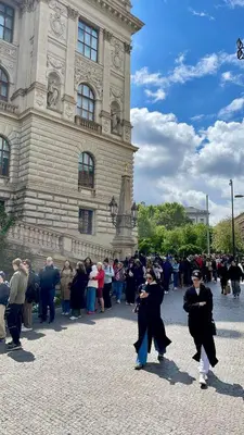 a group of people walking in front of a building at Museum Garden Stay in Prague