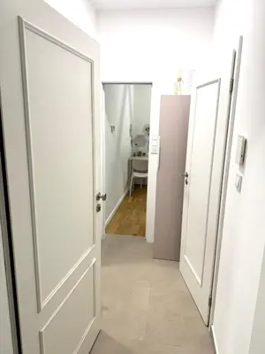 a hallway with an open door and a room at Museum Garden Stay in Prague