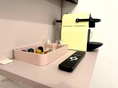 a remote control sitting on a counter next to a cash register at Museum Garden Stay in Prague