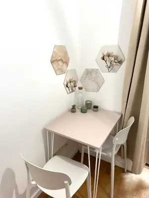 a small white table and chairs in a room at Museum Garden Stay in Prague