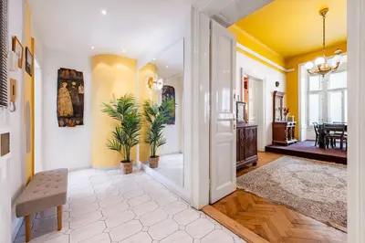 a living room with yellow walls and a doorway at Baroque Grand Apartment XXL - City Center - 160 m2 in Prague