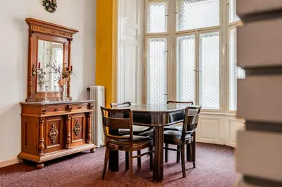 a dining room with a table and chairs and a mirror at Baroque Grand Apartment XXL - City Center - 160 m2 in Prague