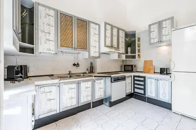 a kitchen with white cabinets and a sink at Baroque Grand Apartment XXL - City Center - 160 m2 in Prague