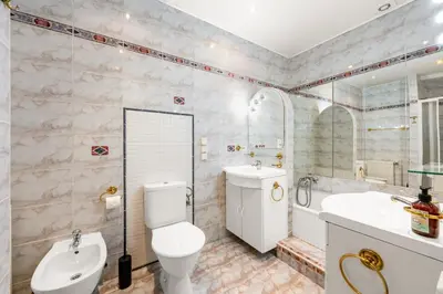a bathroom with a toilet and a sink and a tub at Baroque Grand Apartment XXL - City Center - 160 m2 in Prague
