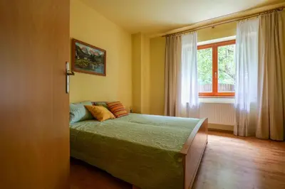 a bedroom with a bed in front of a window at Beautiful house by the river with its own dock in Rabyně