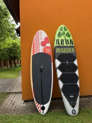 two surfboards leaned up against a wall at Beautiful house by the river with its own dock in Rabyně