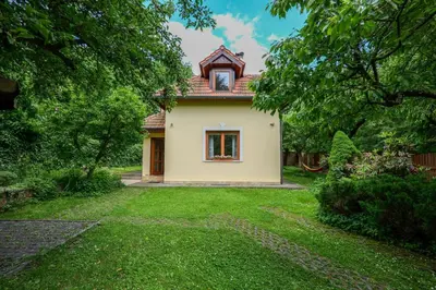 a small house in a garden with a yard at Beautiful house by the river with its own dock in Rabyně