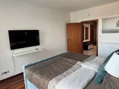 a bedroom with a bed and a flat screen tv at Old town view BOUTIQUE APARTMENT with FREE PARKING in Prague