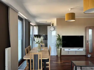 a dining room with a table and a television at Old town view BOUTIQUE APARTMENT with FREE PARKING in Prague