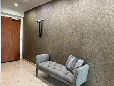 a couch sitting in a room with a wall at Old town view BOUTIQUE APARTMENT with FREE PARKING in Prague