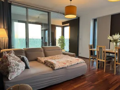 a living room with a couch and a dining room at Old town view BOUTIQUE APARTMENT with FREE PARKING in Prague