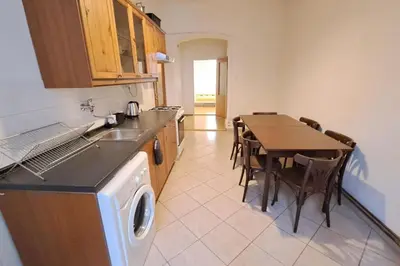 a kitchen with a table and a washing machine at Skyline Nest on Borivojova in Prague