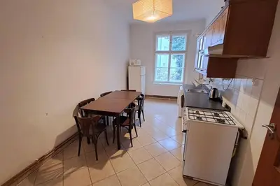a kitchen with a table and a kitchen with a stove at Skyline Nest on Borivojova in Prague