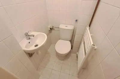 a small bathroom with a toilet and a sink at Skyline Nest on Borivojova in Prague