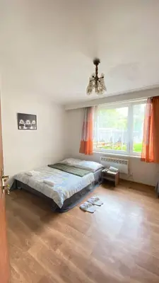 a bedroom with a bed and a large window at ALEX-ASIE-EU penzion in Unhošť