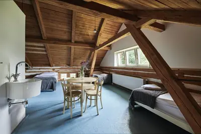 a bedroom with a table and chairs in a room at Hájovna u Bažantnice in Pěčice