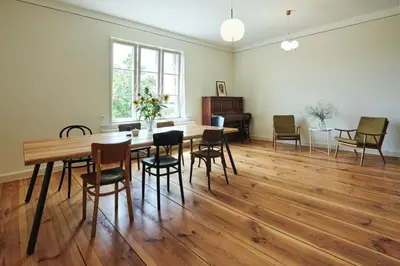 a dining room with a wooden table and chairs at Hájovna u Bažantnice in Pěčice