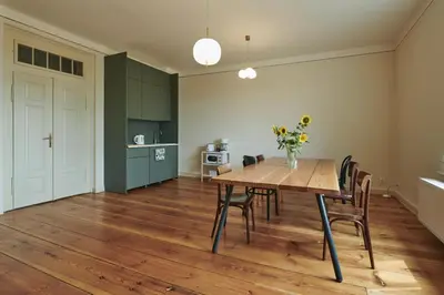 a dining room with a wooden table and chairs at Hájovna u Bažantnice in Pěčice