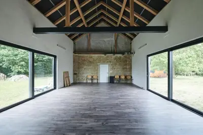 a large room with windows and chairs in it at Hájovna u Bažantnice in Pěčice