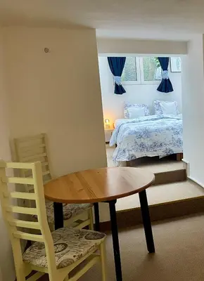 a room with a table and a bed and a table and chair at PodPrahou - Na Petynce in Prague