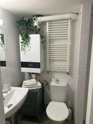 a room with a white cabinet and a chair at PodPrahou - Na Petynce in Prague