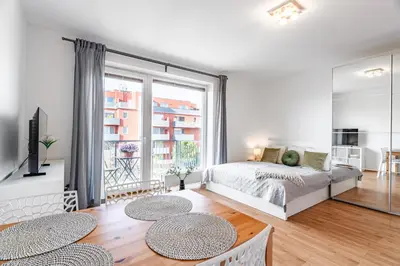 a bedroom with a bed and a large window at Airport Apartman Víšek in Chýně