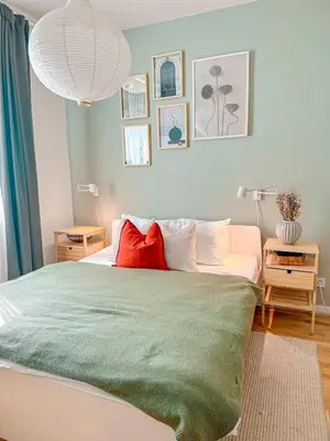 a bedroom with a large bed with two red pillows at True Relax Apartman 2 bedrooms Wenceslas square in Prague