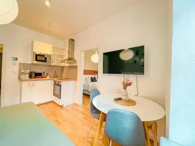a kitchen and living room with a table and chairs at True Relax Apartman 2 bedrooms Wenceslas square in Prague